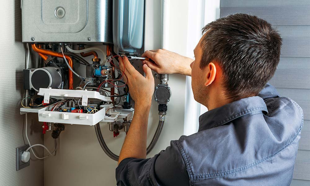 Technician servicing heating equipment