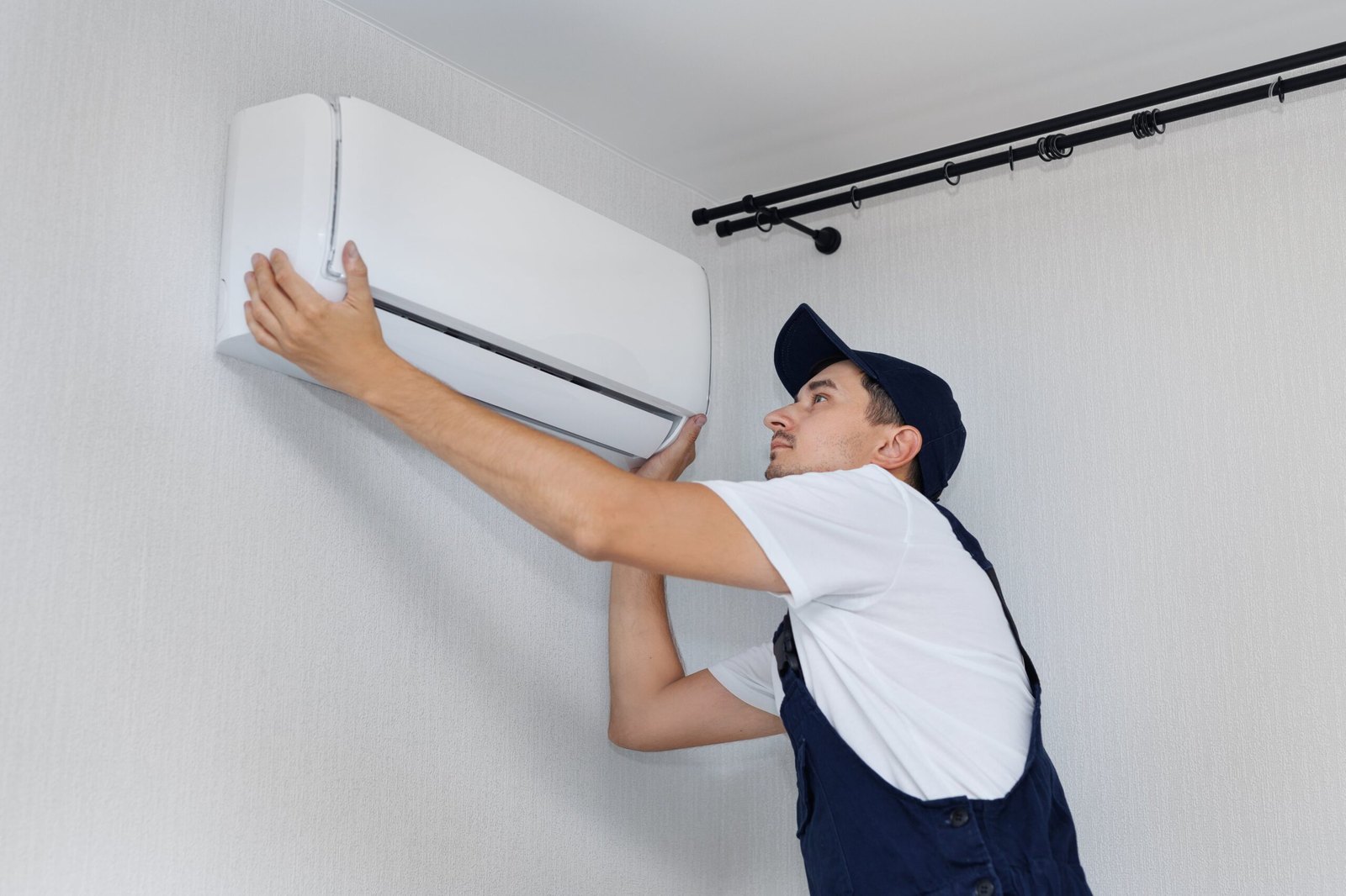 Technician installing a mini-split air conditioner