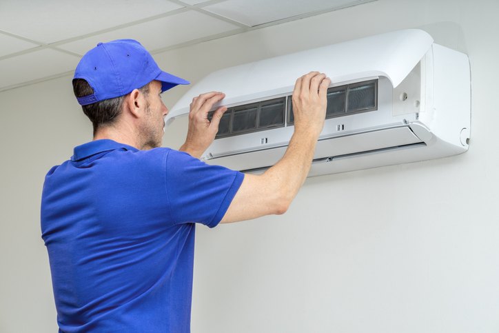 Technician servicing a mini-split air conditioner